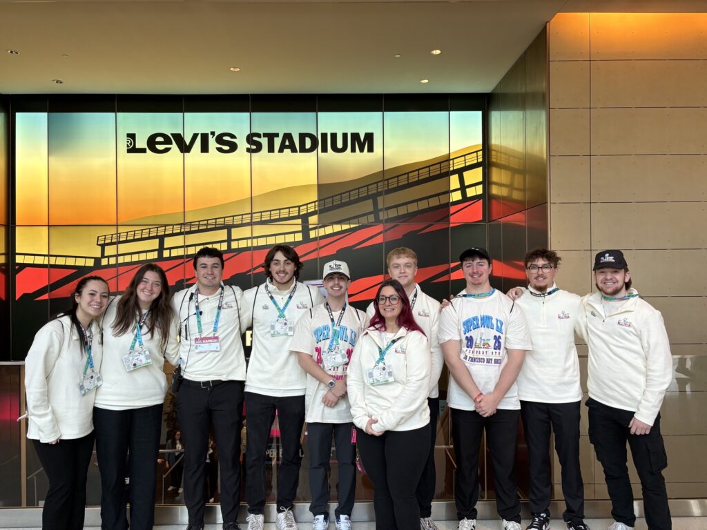 Dr. Tiffany Demiris (center) poses with St. Bonaventure University sports management students inside Levi’s Stadium, host of Super Bowl LX, during their event operations assignment. The students worked in stadium and fan operations as part of the School of Business’ experiential learning program. (Photo courtesy of Aliyah Giudice)